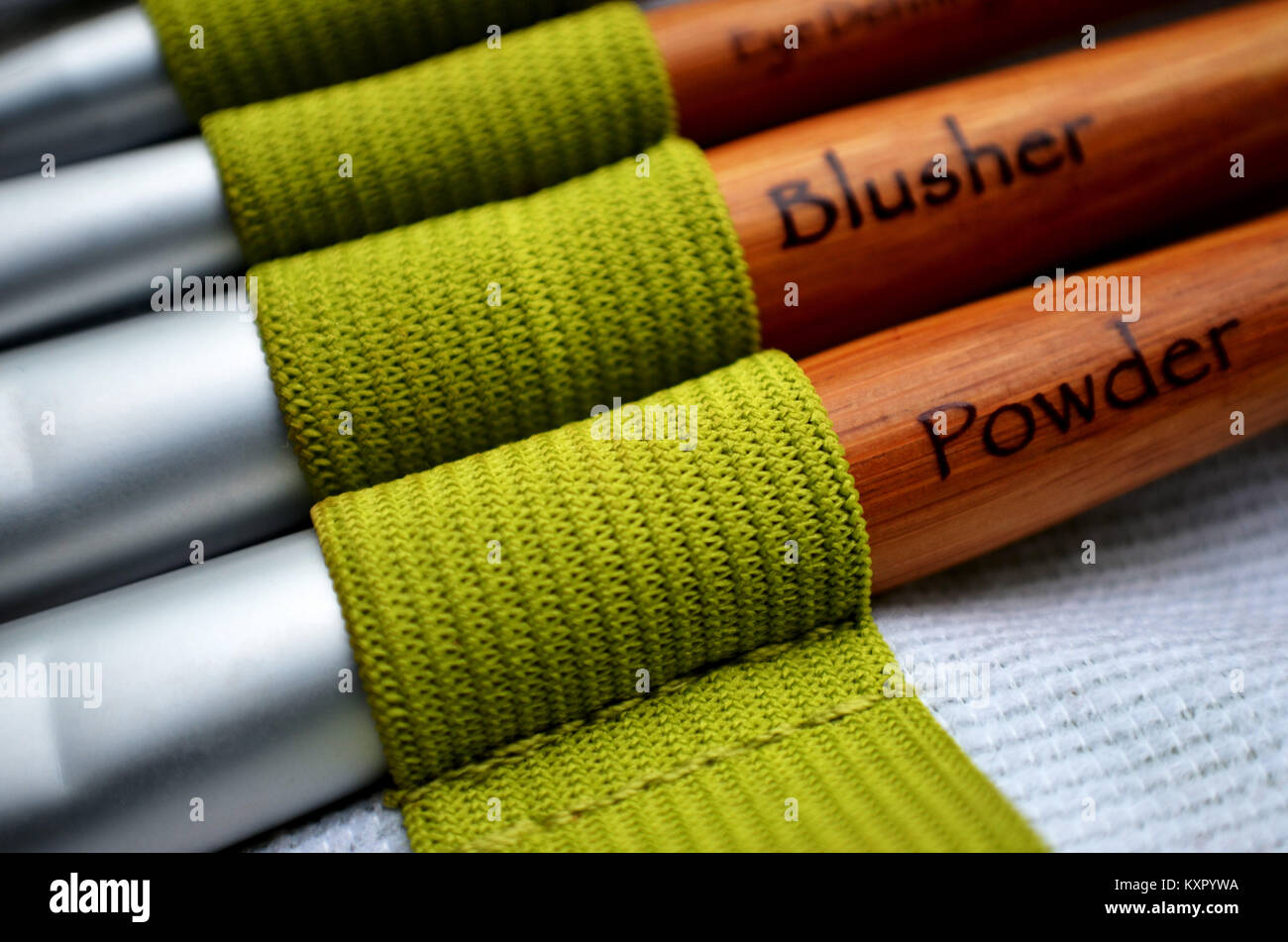 Set of makeup brushes in green holder Stock Photo