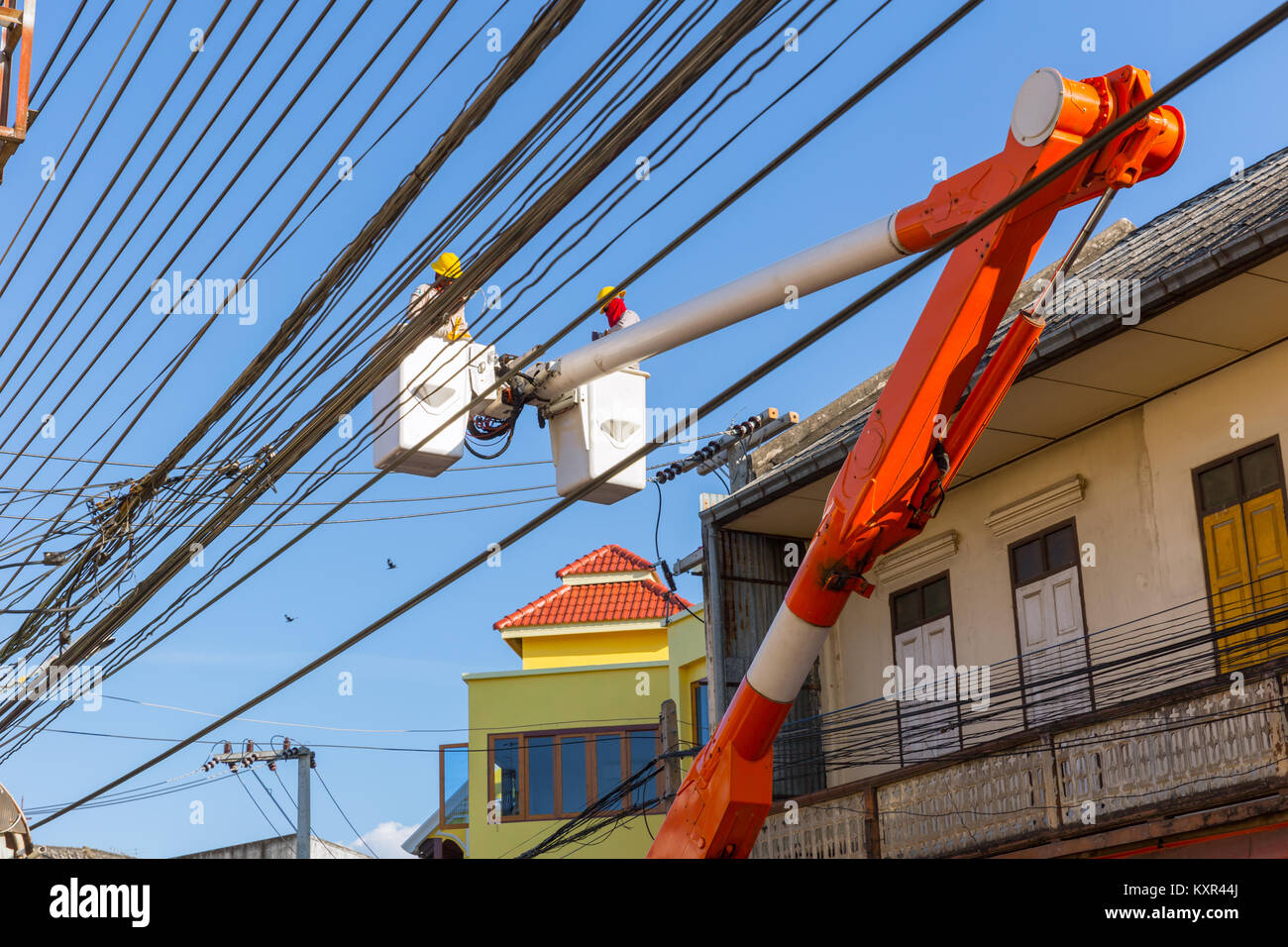 lineman duty working fix power line on electrical cable with aerial