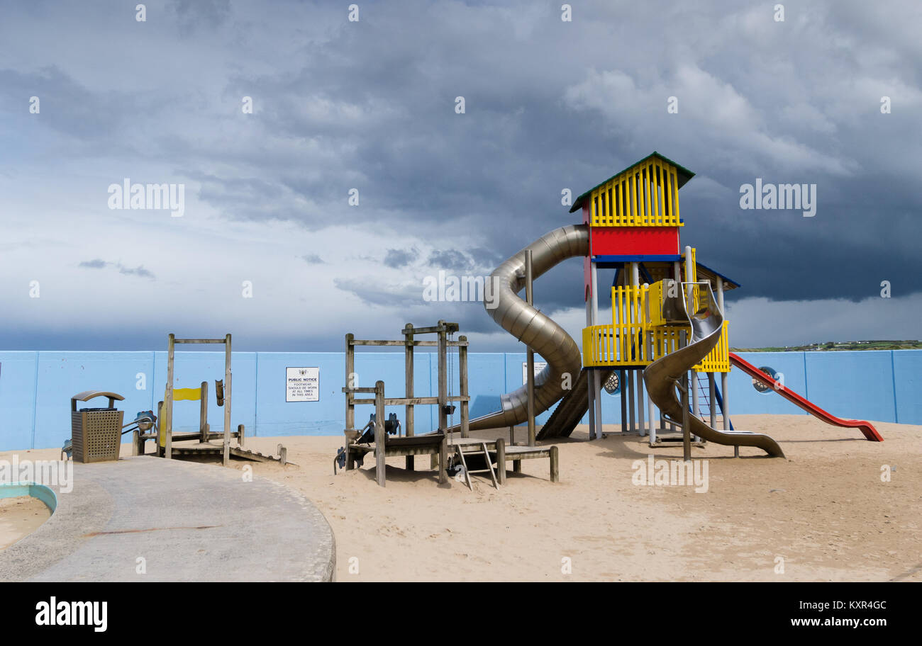 A chidrens' playground with a stormy sky in the background. Stock Photo