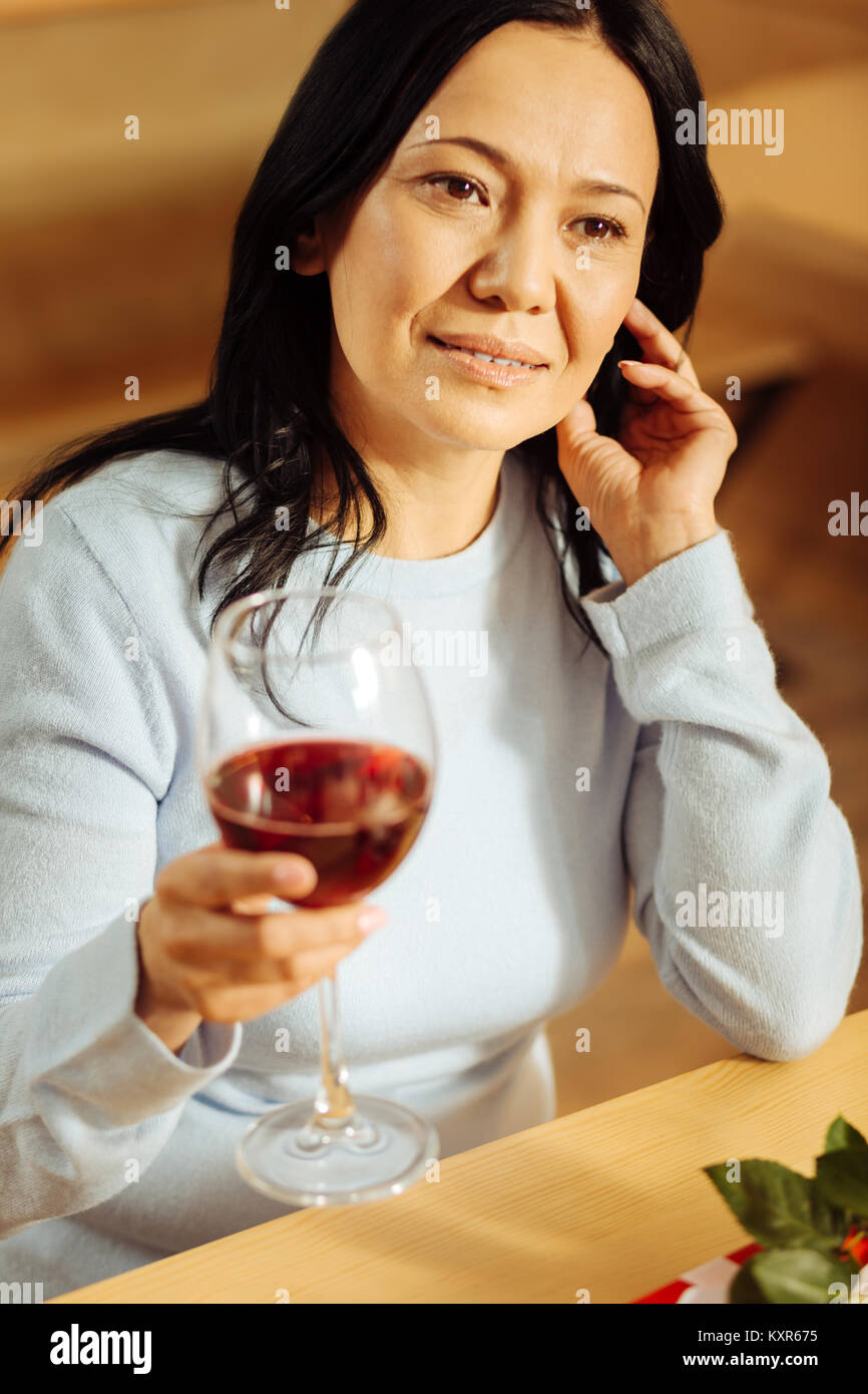 Cheerful woman drinking red wine Stock Photo