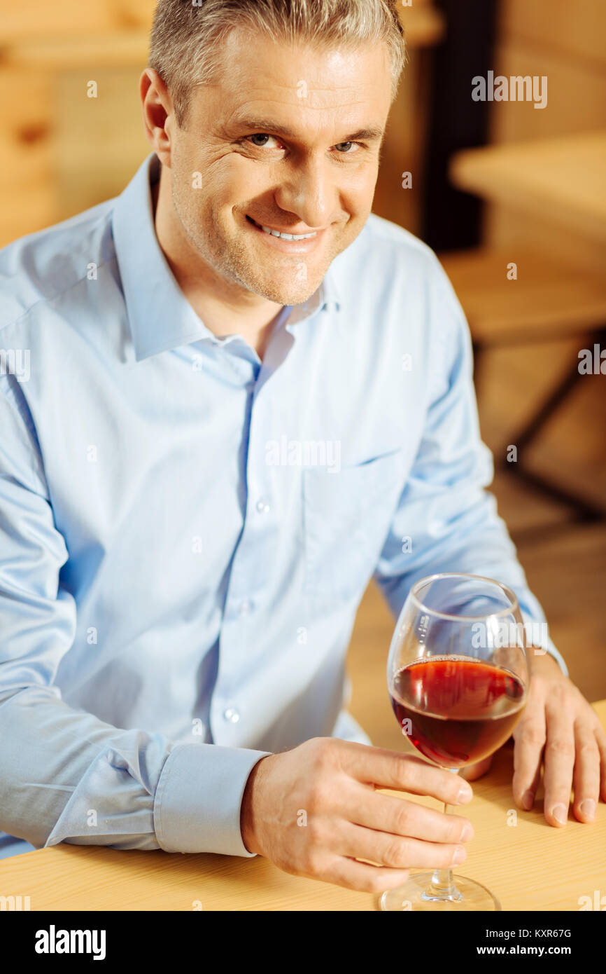 Inspired man relaxing and drinking wine Stock Photo