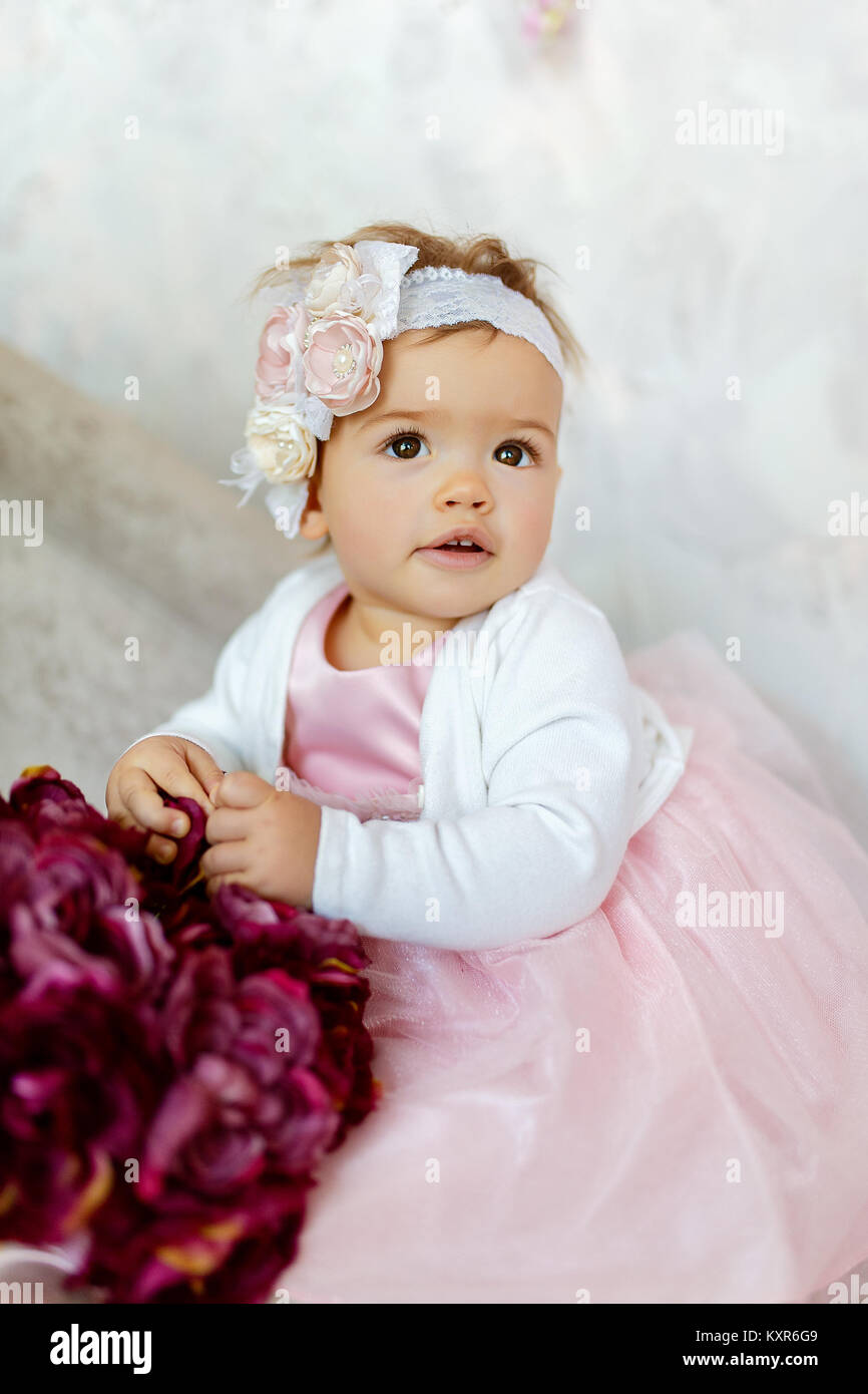 Portrait of a beautiful little baby in pink dress and . Close-up Stock ...