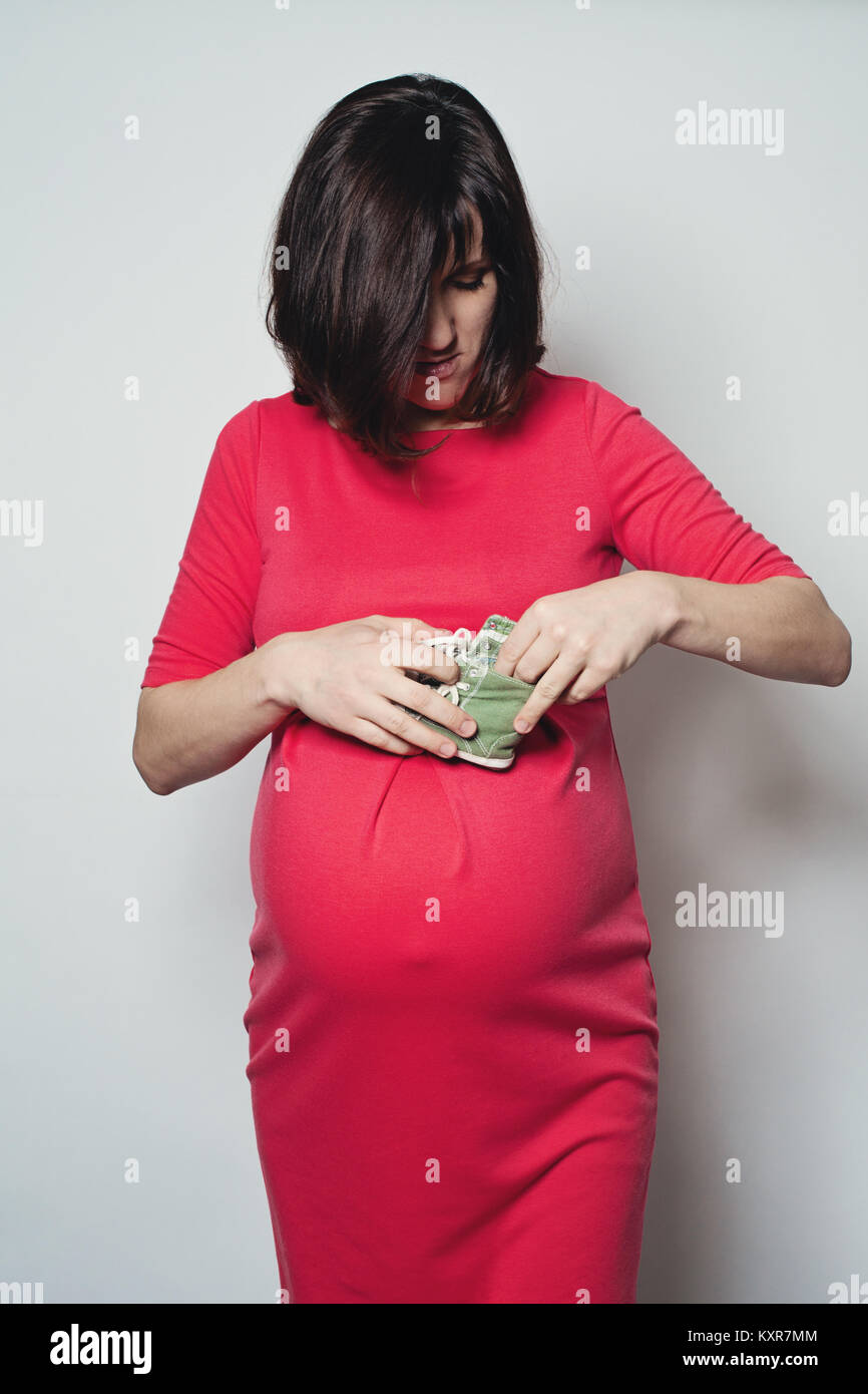 Pregnant woman in red dress hi-res stock photography and images - Alamy
