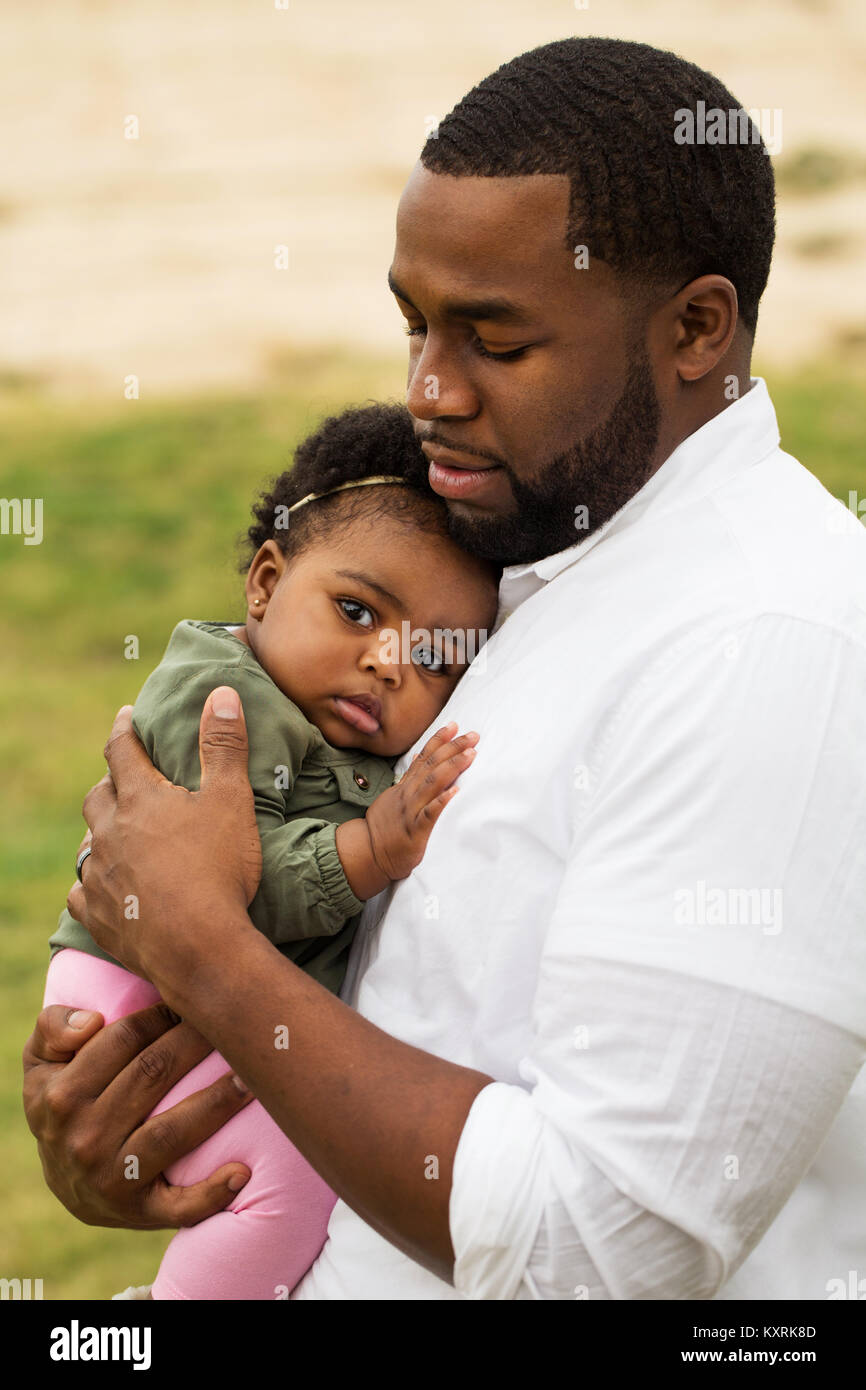 African American loving father holding his daughter Stock Photo - Alamy