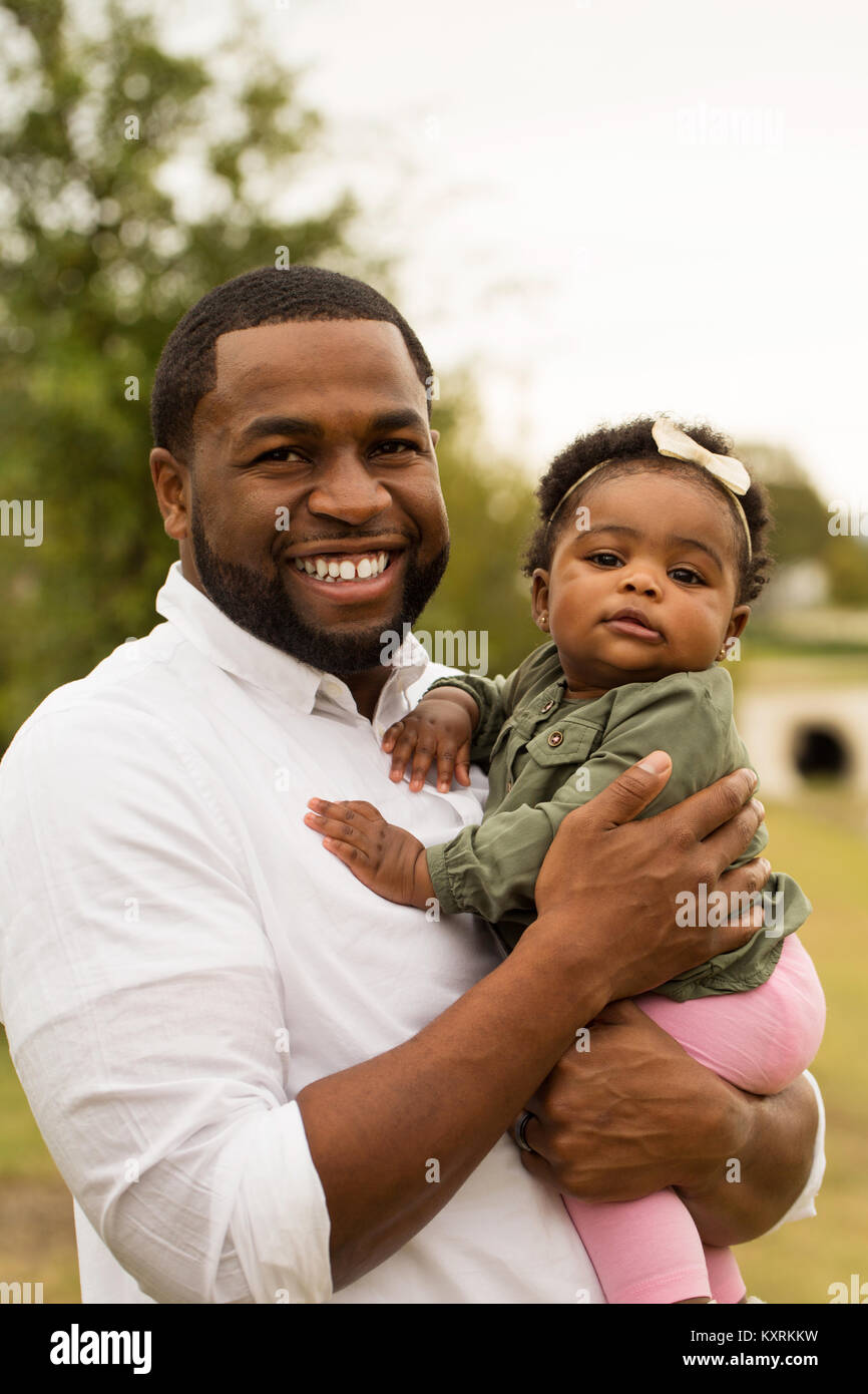 African American loving father holding his daughter Stock Photo - Alamy