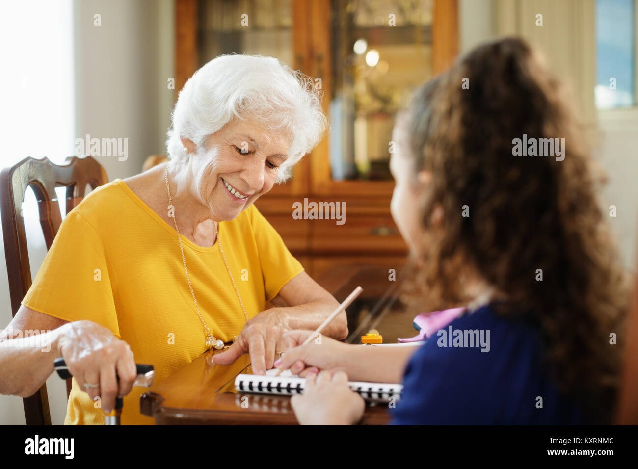 Child helping elderly person hi-res stock photography and images - Alamy