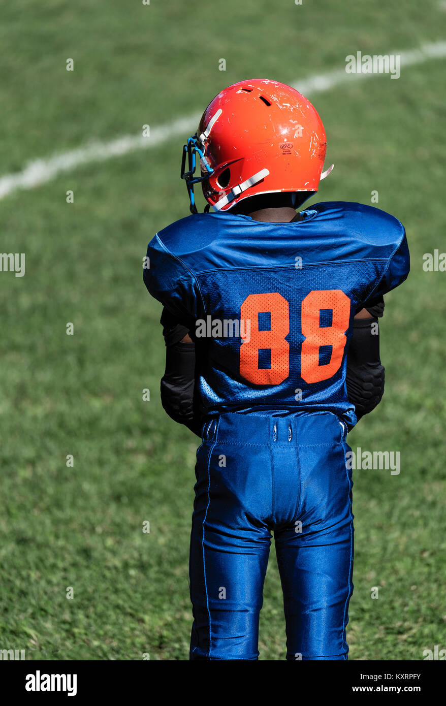 Young boys on the sideline of a Pop Warner football game, USA. Stock Photo