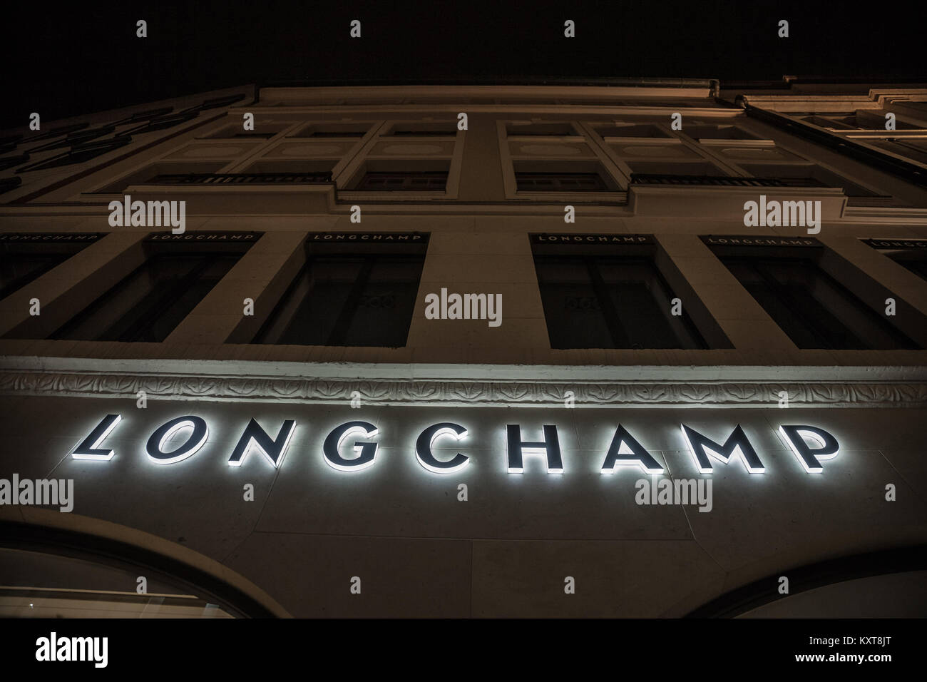 MUNICH, GERMANY - DECEMBER 17, 2017: Longchamp logo on their Munich main shop taken at night. Longchamp is a French luxury leather goods company, foun Stock Photo