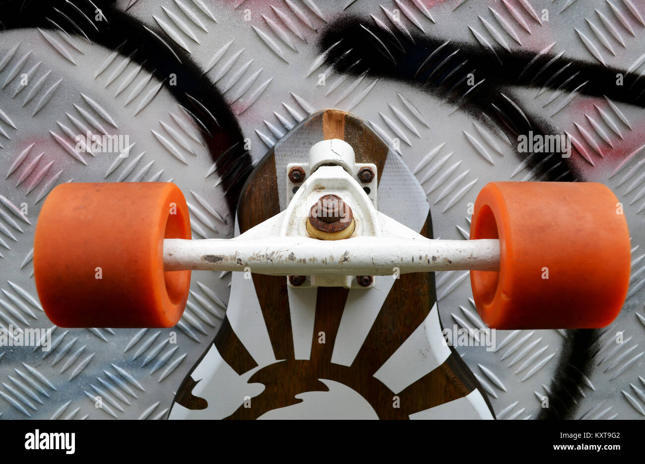 Longboard skateboard leaning against wall with graffiti Stock Photo Alamy