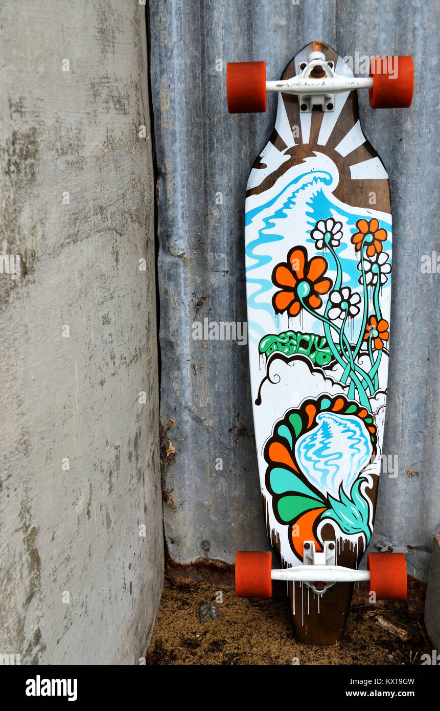 Longboard skateboard leaning against a wall Stock Photo - Alamy