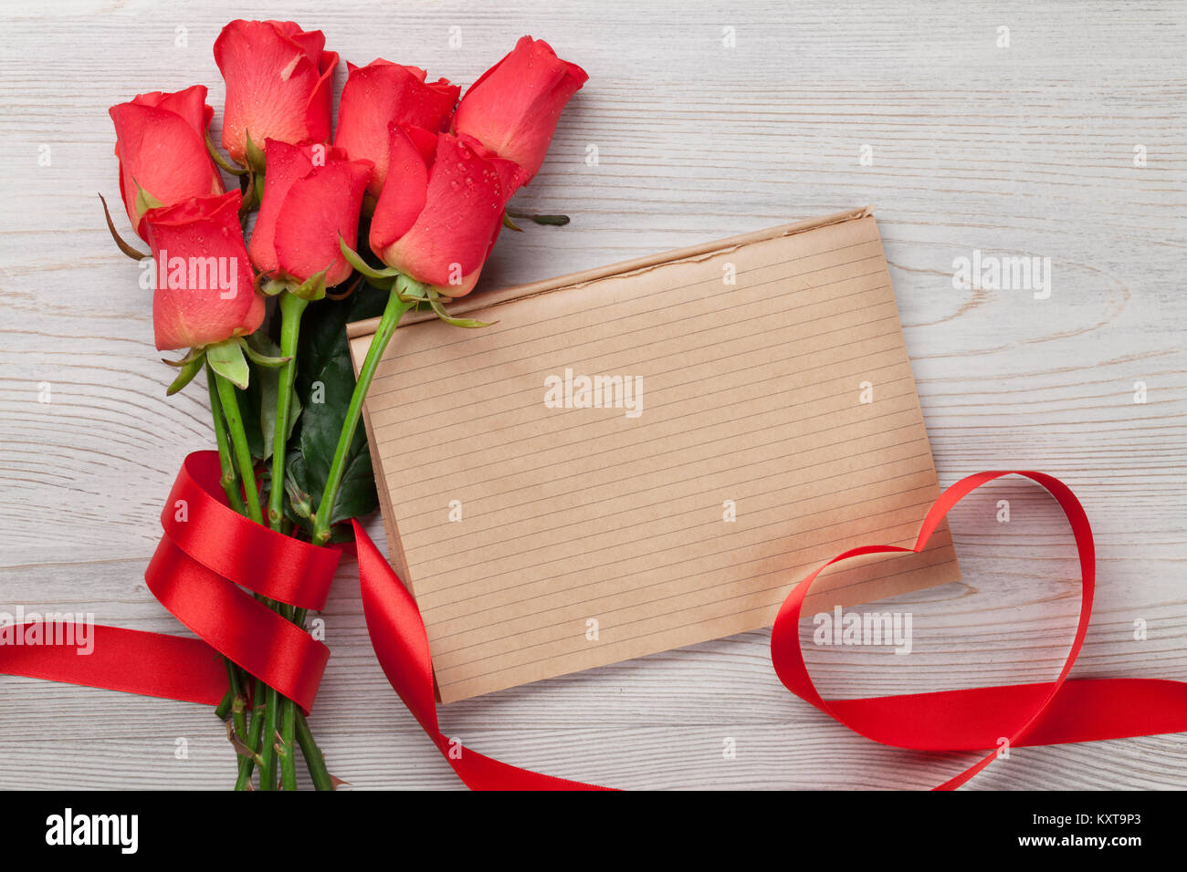Valentines day greeting card with red rose flowers and notepad on ...