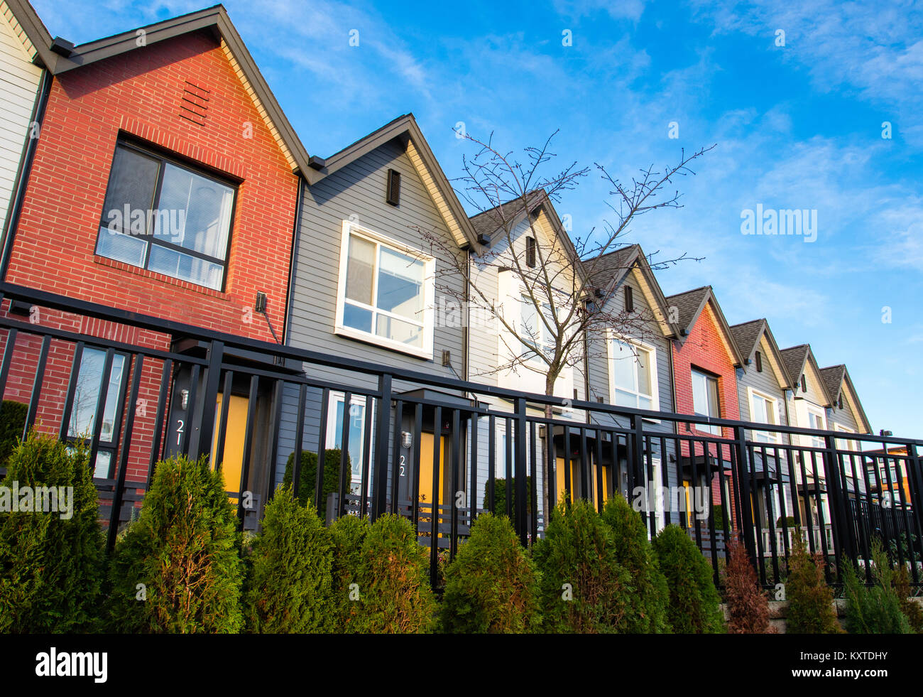 Image showcasing Colorful new modern luxury townhouses Stock Photo - Alamy