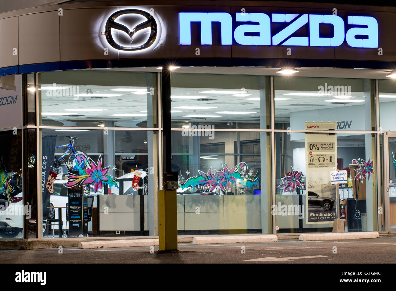 Vancouver. Canada - January 9, 2018: Mazda logo on the facade of official dealer office. Mazda Motor Corporation is a Japanese car brand, automotive m Stock Photo