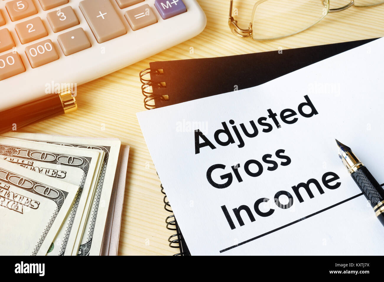 Document with title Adjusted gross income AGI. Stock Photo