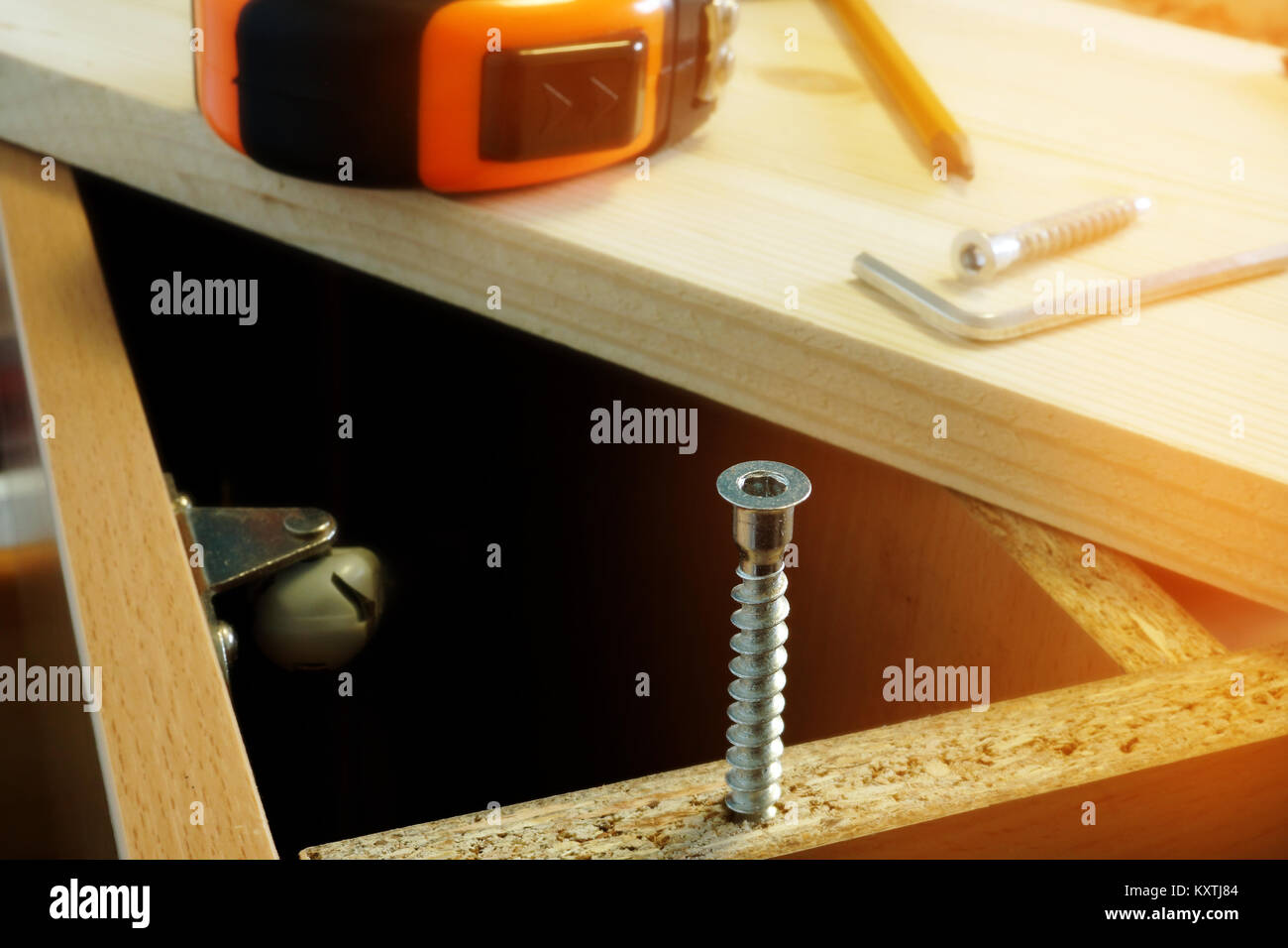 Furniture assembling. Parts of cabinet and screw close up. Stock Photo