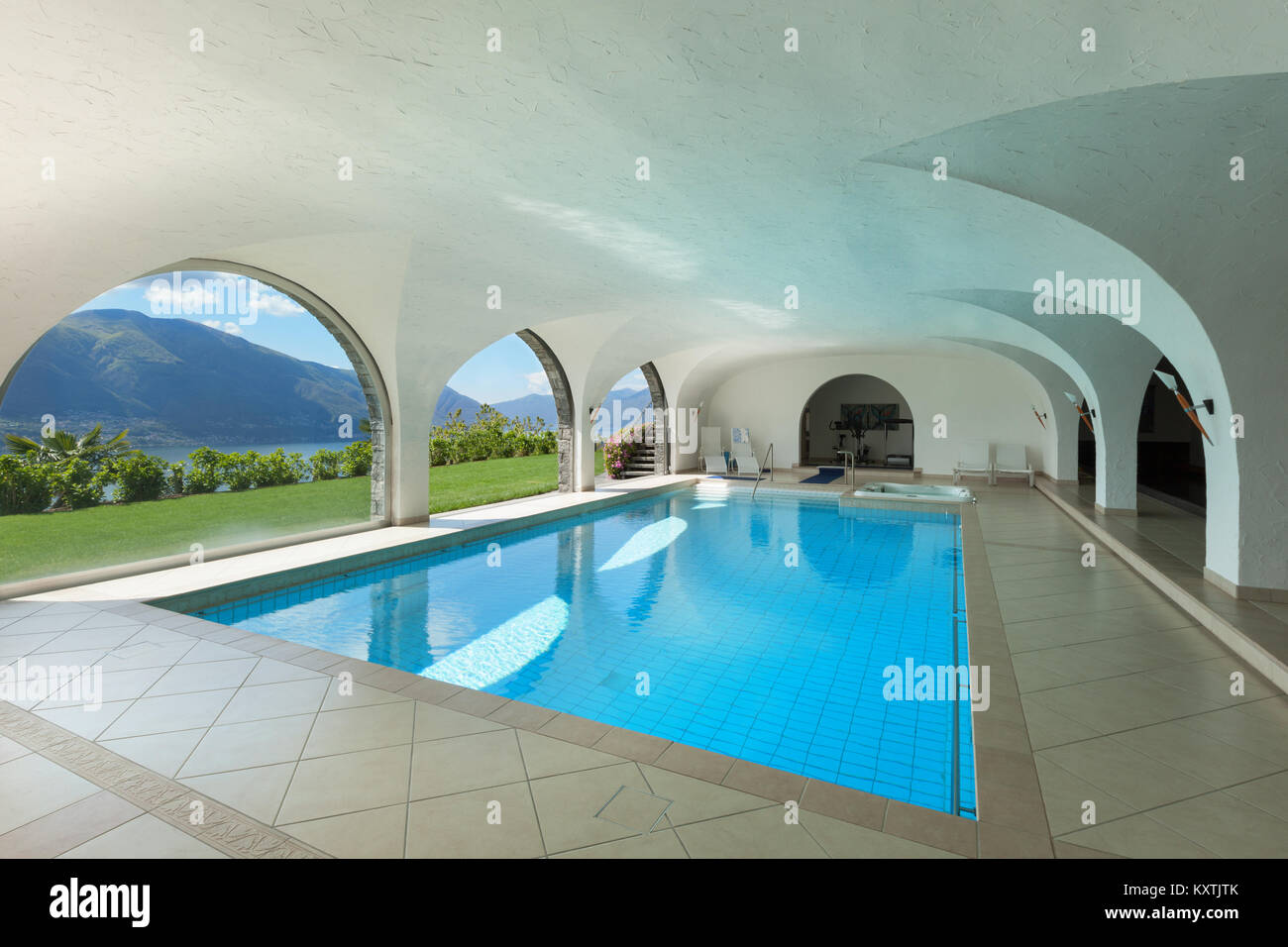 Luxury villa with indoor swimming pool, arched windows Stock Photo - Alamy