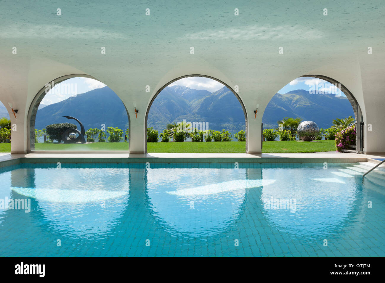 Luxury villa with indoor swimming pool, arched windows Stock Photo - Alamy