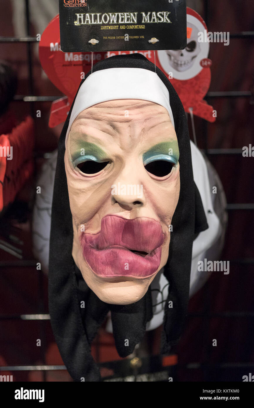 A scary nun in a habit mask for sale at the Halloween adventure costume and novelty story on Broadway in Greenwich Village, New York City. Stock Photo