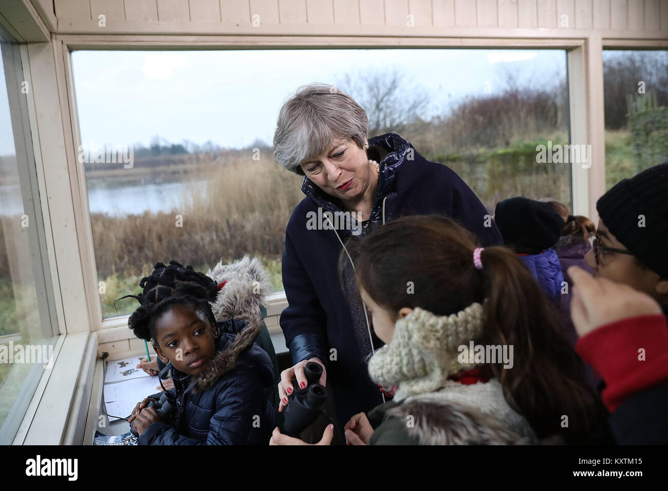 Prime Minister Theresa May talks to school children inside a bird hide at the London Wetland Centre in South West London, where she set out her vision for protecting the environment. Stock Photo