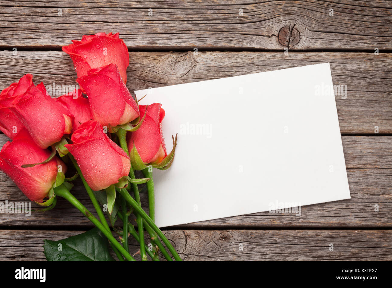 Valentines day greeting card with red roses on wooden background. Top ...