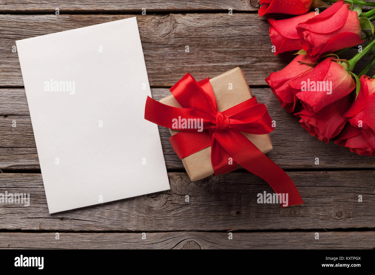 Valentines day greeting card with red rose flowers and gift box on ...