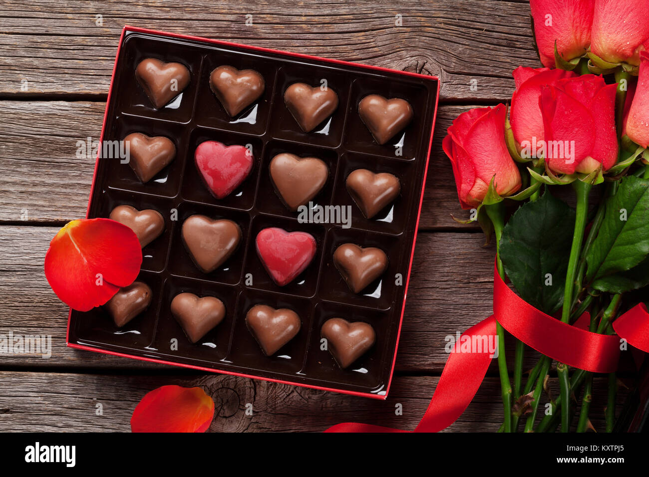 Valentines day greeting card with red roses and heart shaped chocolate ...