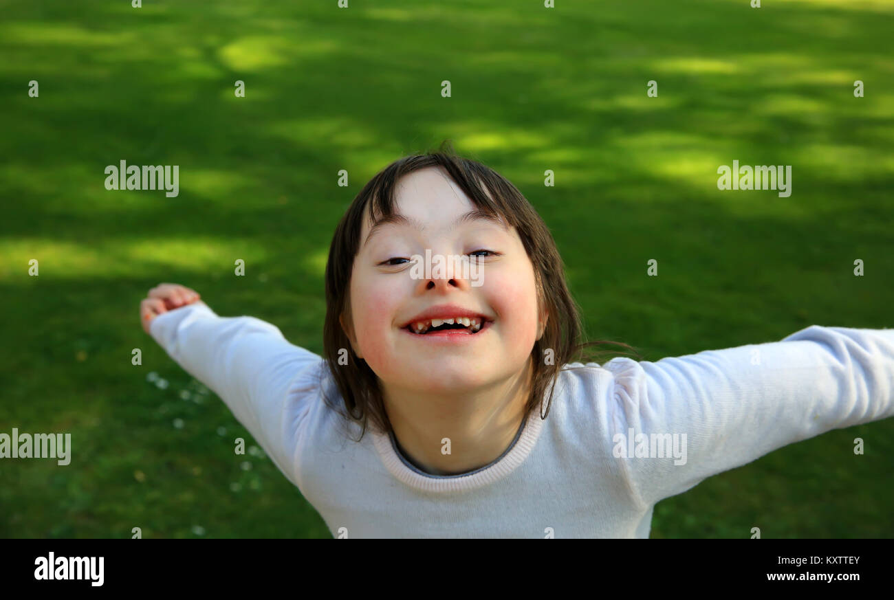 Portrait of little girl smiling outside Stock Photo - Alamy