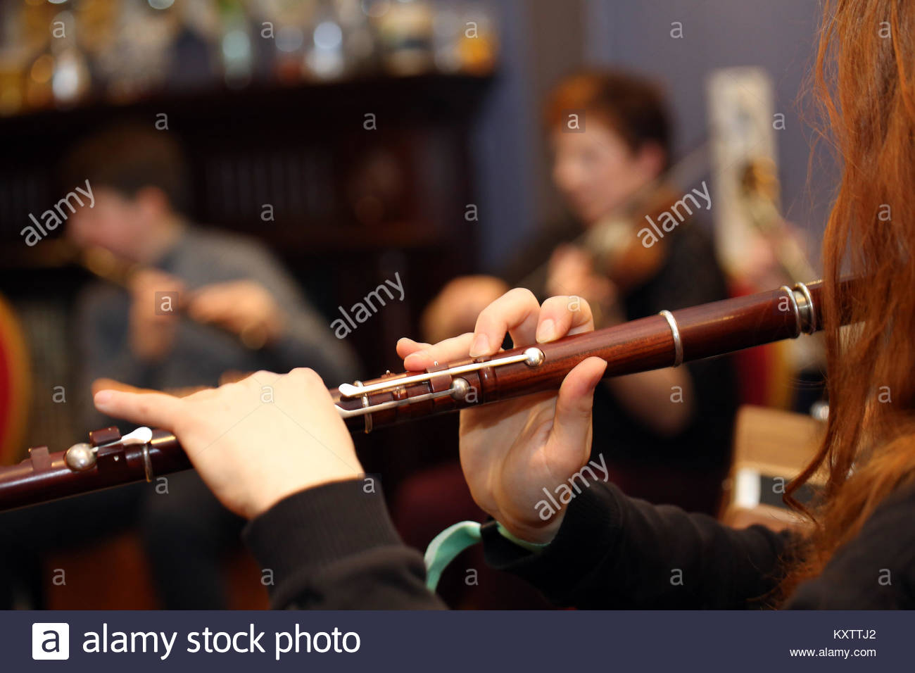 A young redhaired irish traditional musician plays a tune at a 2017 music festival in Kerry, Ireland Stock Photo