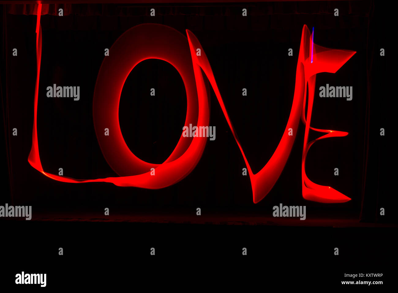 Love light painting - word love in red letters against black background - painting with light, light painting Stock Photo
