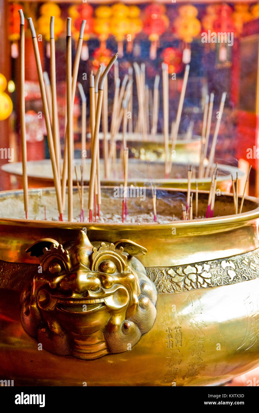 A close up of a lion head handle from a bronze incense bowl in the Chinese Kek Lok Si Temple during Chinese New Year. Stock Photo