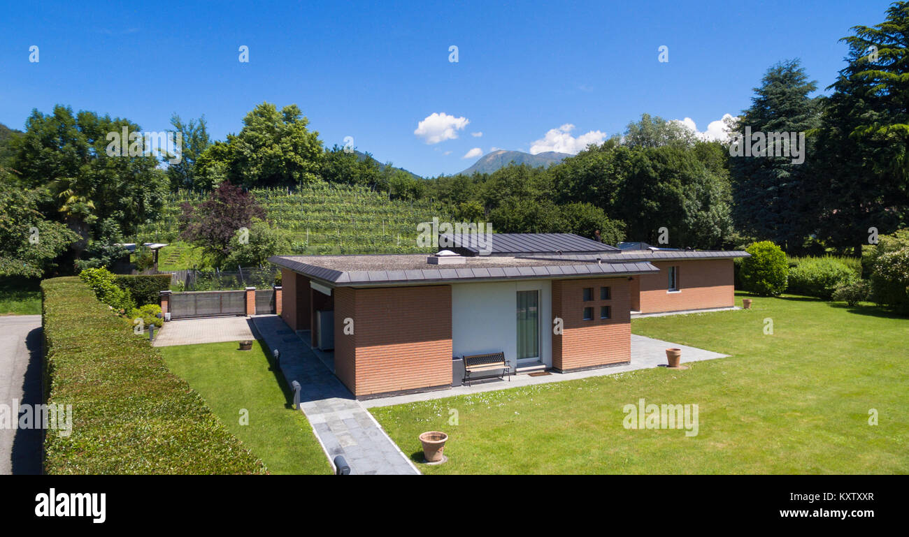 Modern brick house with garden, outdoors Stock Photo - Alamy