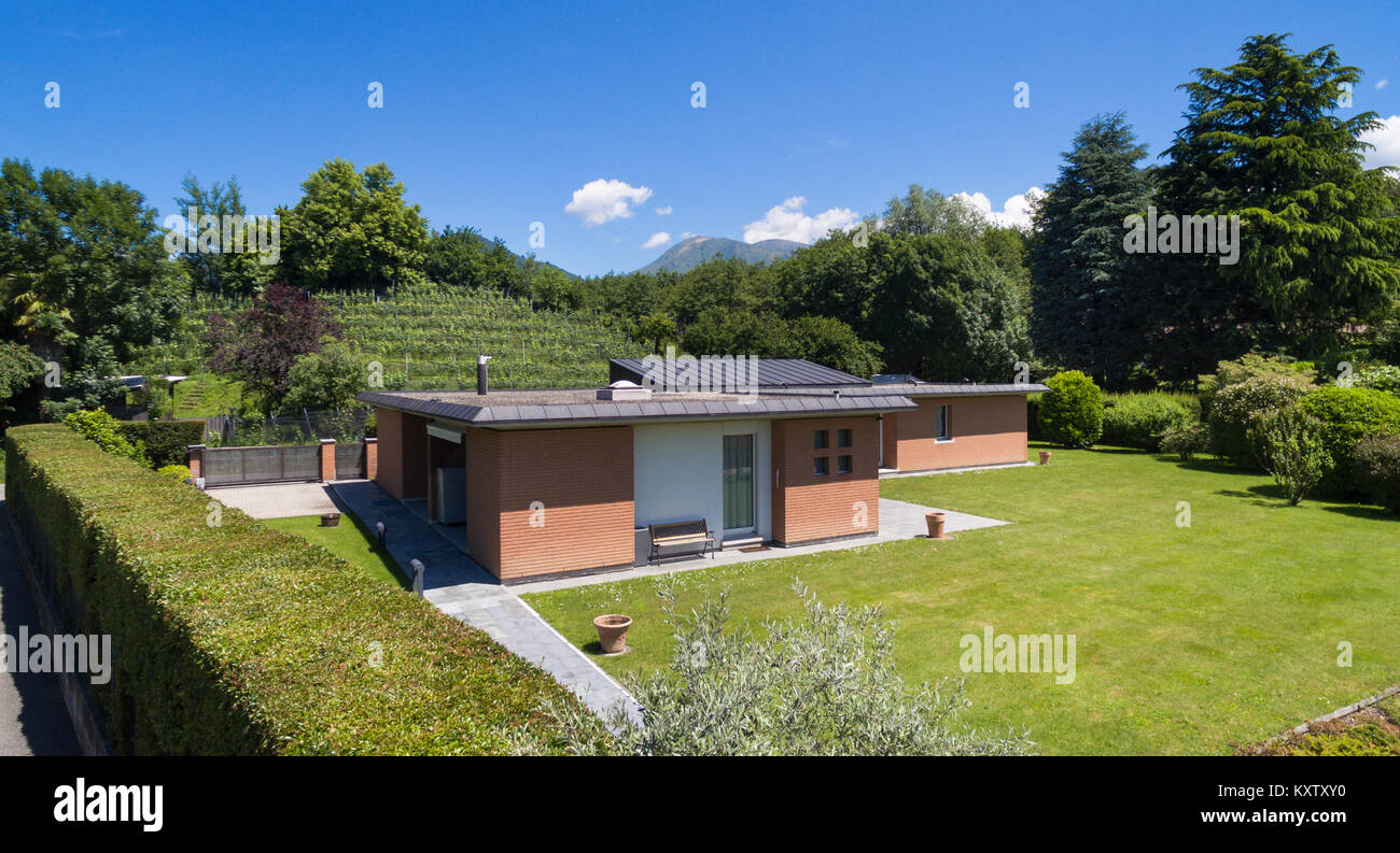 Modern brick house with garden, outdoors Stock Photo - Alamy