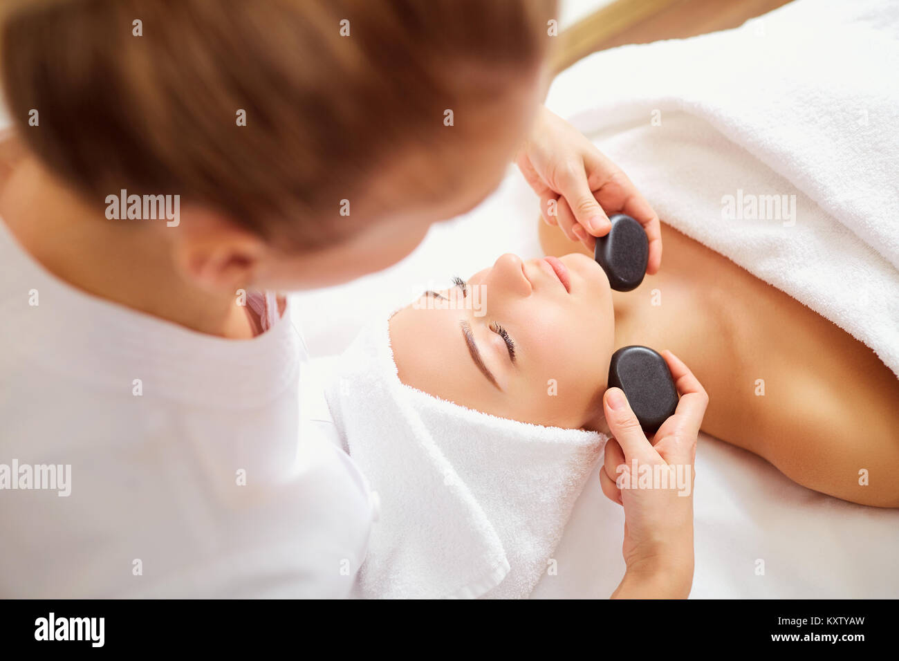 Massage face woman stone therapy. Stock Photo