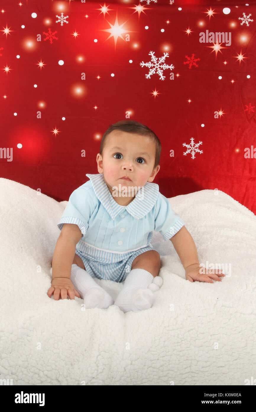 mixed race baby boy playing on soft rug Stock Photo