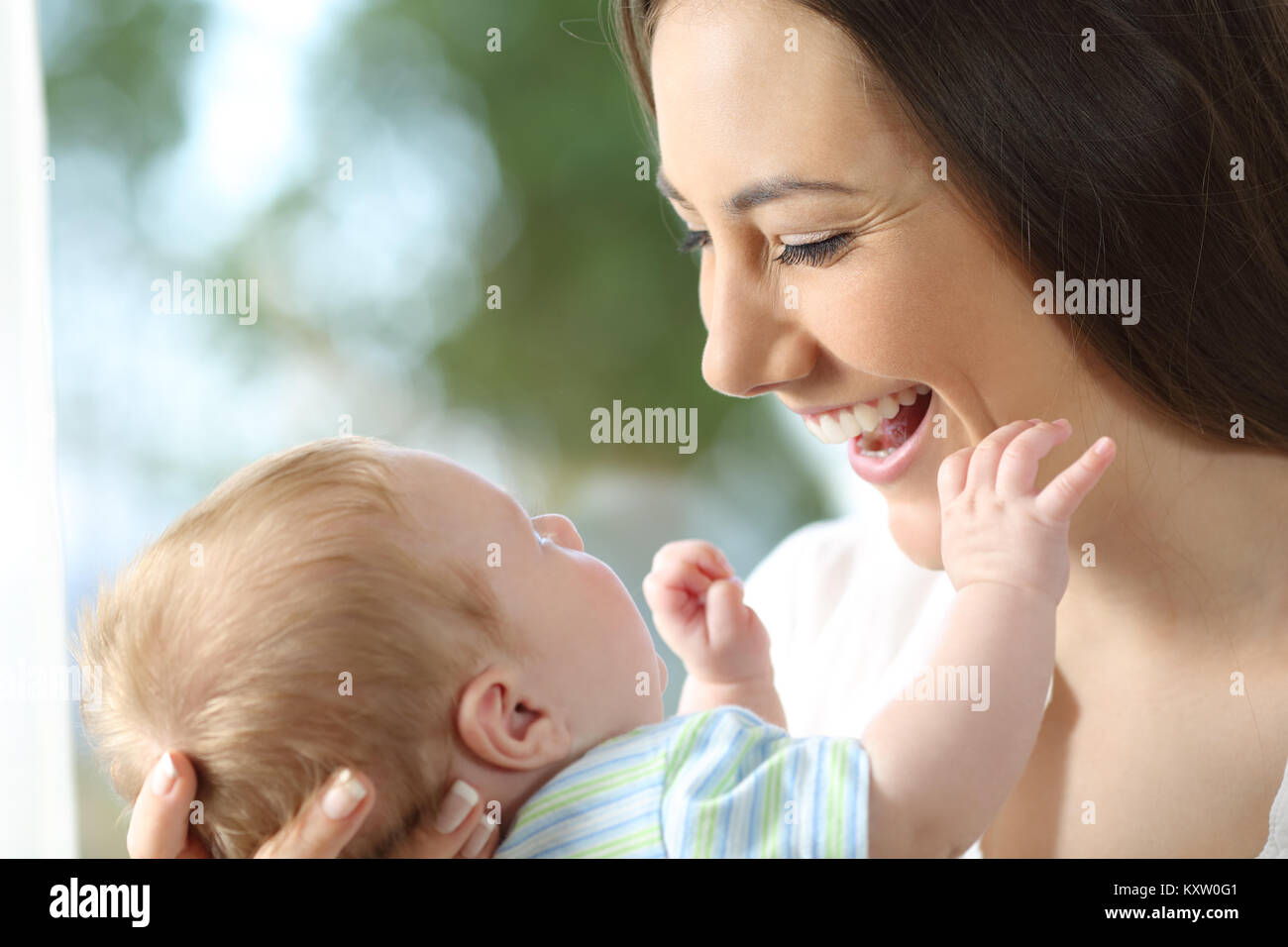 Close up portrait of a happy mother looking at her newborn baby Stock Photo