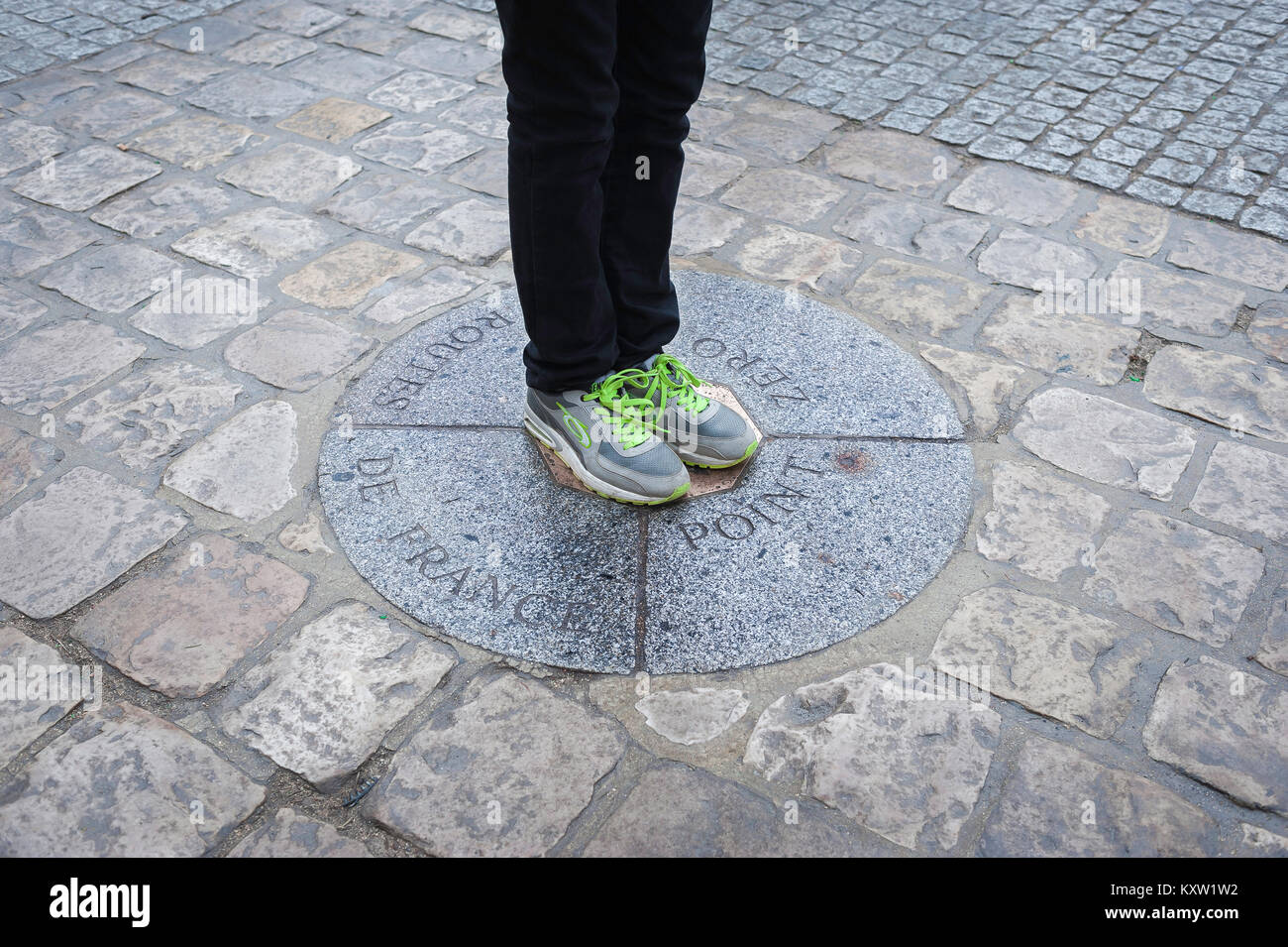 Point Zero Paris, a young person stands on Point Zero - the precise spot from which all distances from Paris to other locations in France is measured. Stock Photo
