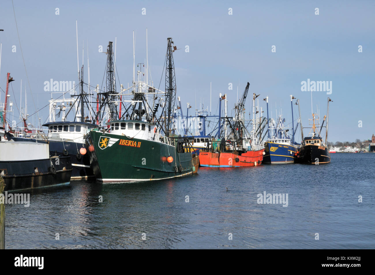 Fishing trawlers rafted along side each other at wharf in New Bedford harbor, New Bedford, Massachusetts the world's most famous whaling era seaport Stock Photo