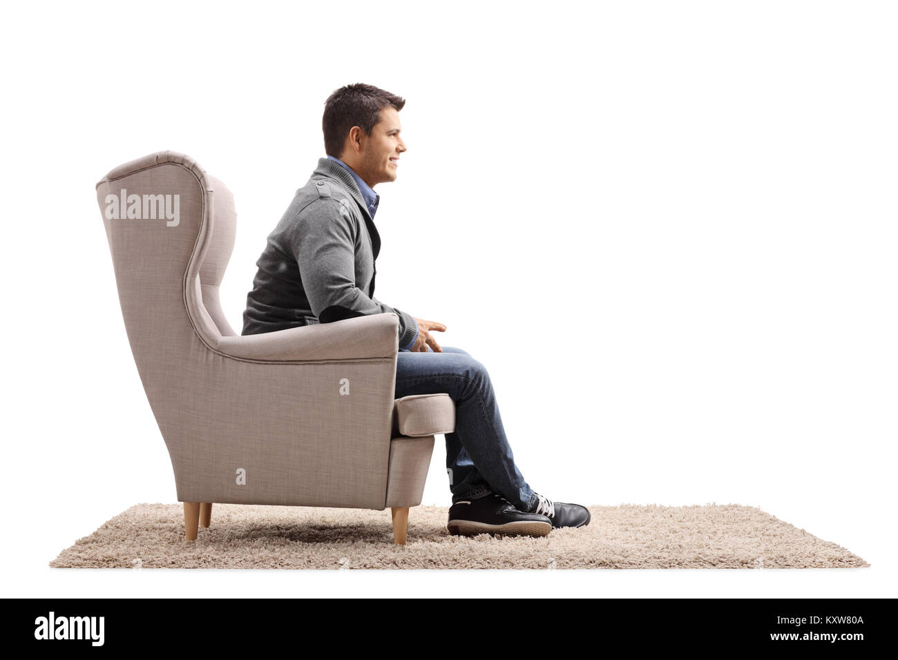 Man sitting in an armchair isolated on white background Stock Photo Alamy