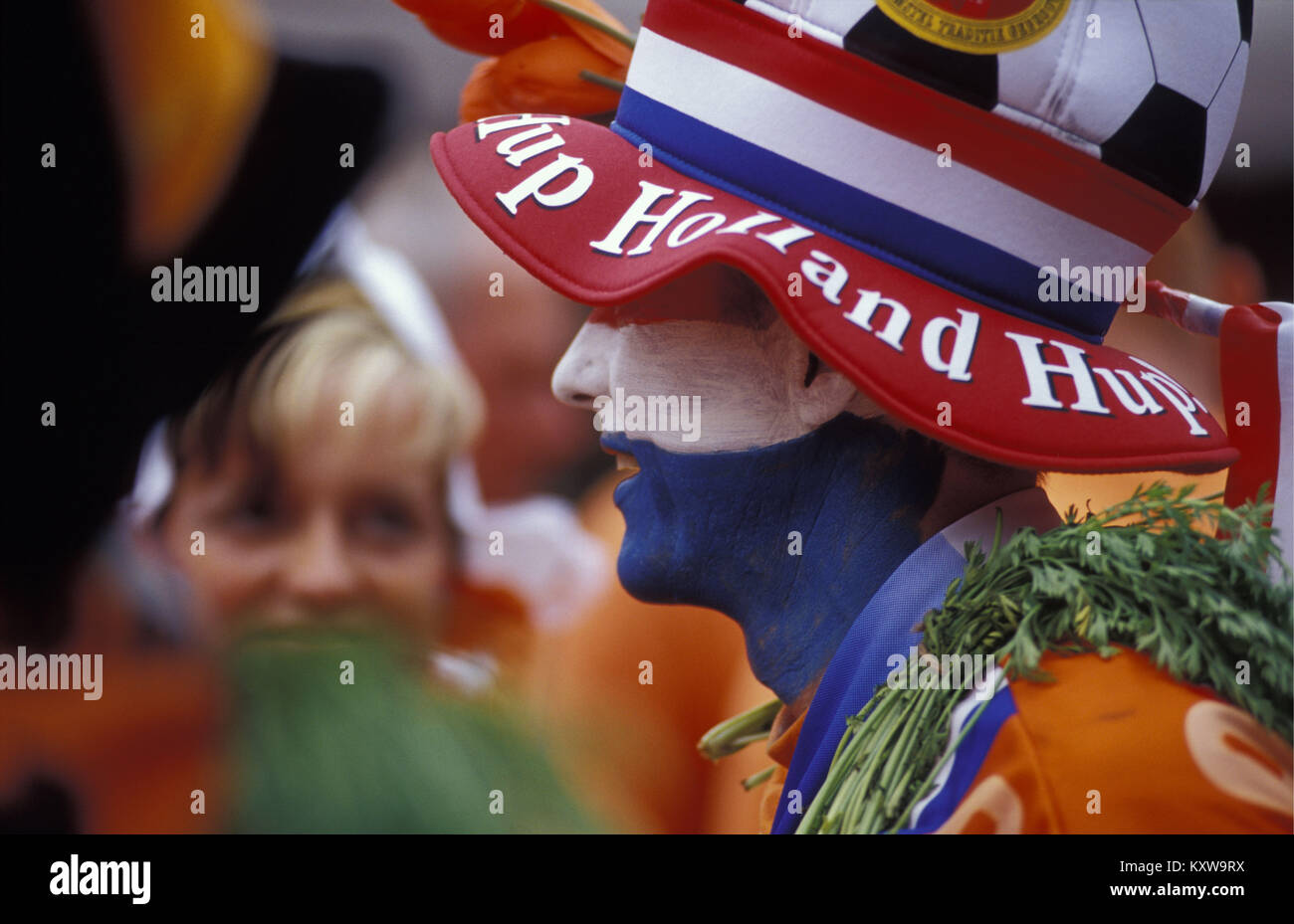 The Netherlands. Amsterdam. Supporters of Dutch football team in national colours. Flag (red, white, blue) and national colour (orange). Stock Photo