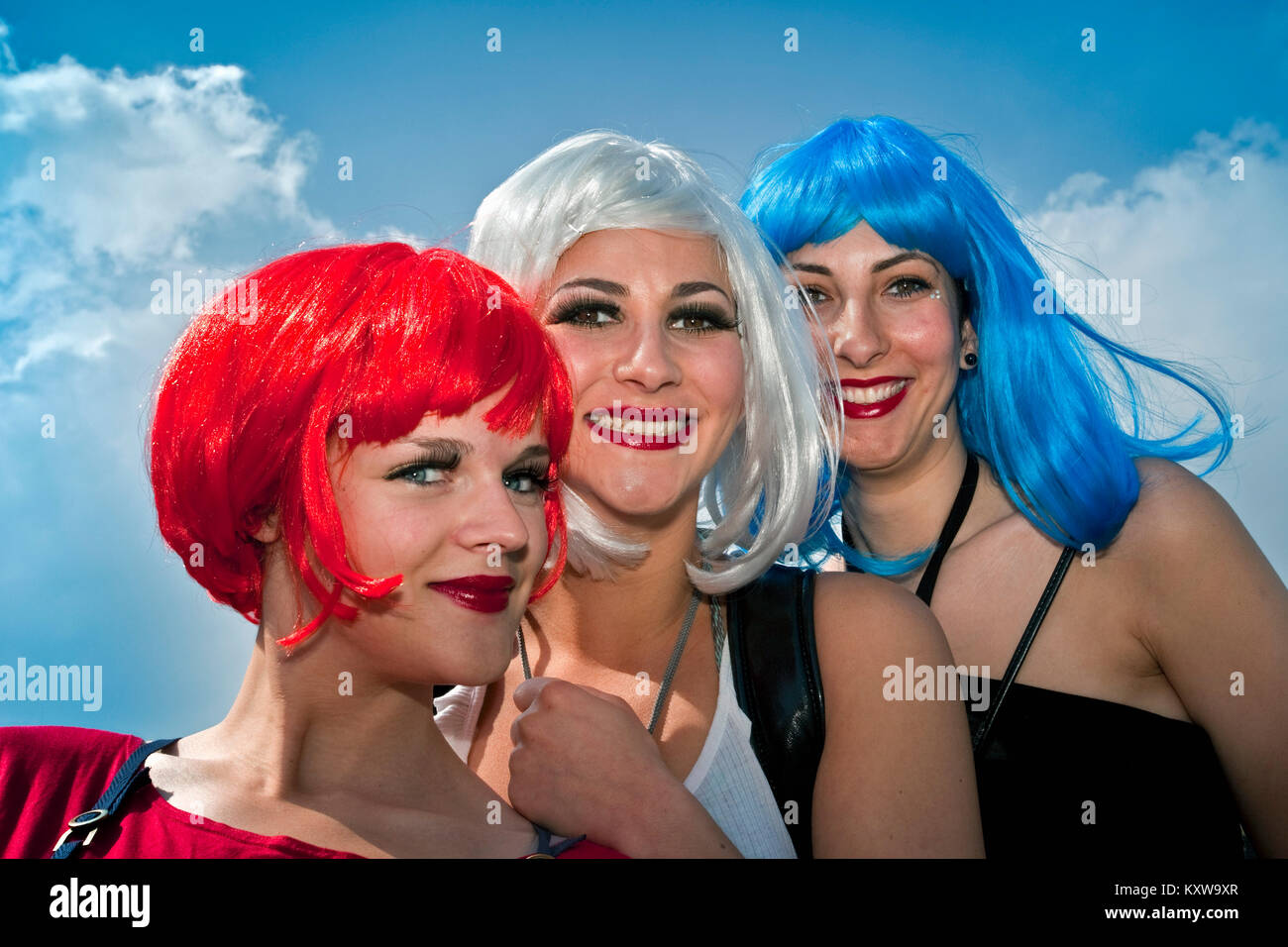 The Netherlands. Amsterdam. Annual festival on 27 april called Koningsdag (Kingsday), celebrating the king's birthday. Women with wigs in national col Stock Photo