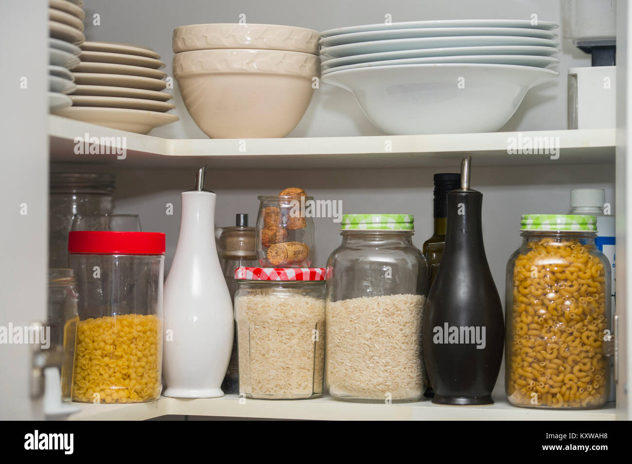 A Food Pantry With Storage Jars Rice Pasta Jasmine Plates And