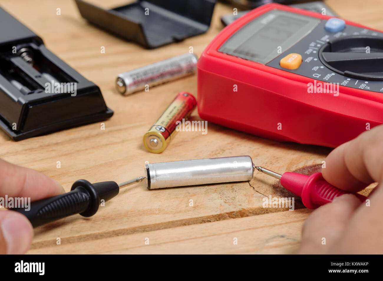 electrician using the digital multimeter to check the battery Stock