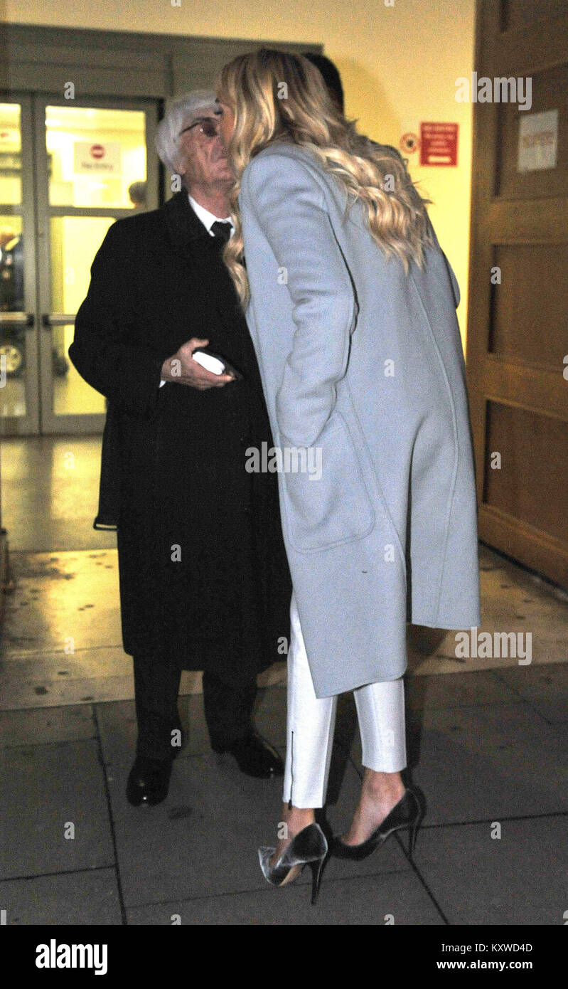 Tycoon Bernie Ecclestone kisses his daughter Petra Ecclestone, as they leave London's Central Family Court where she had the latest hearing in her divorce battle with ex-husband James Stunt. Stock Photo