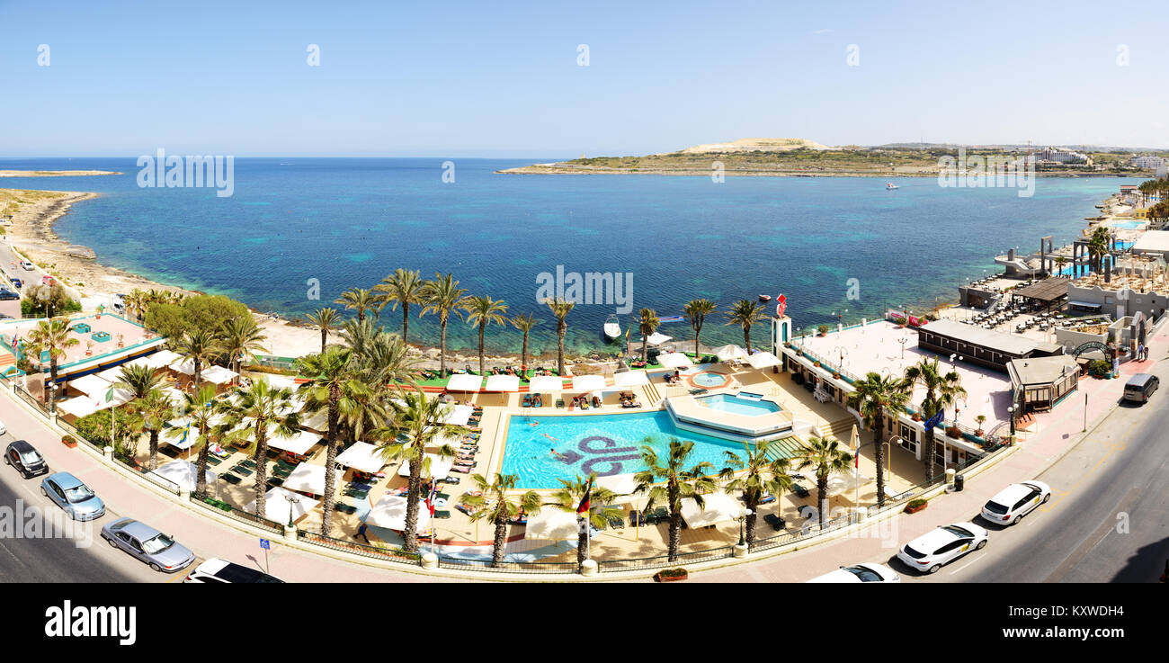 BUGIBBA, MALTA - APRIL 23: The tourists are on vacation at popular hotel on April 23, 2015 in Bugibba, Malta. More then 1,6 mln tourists is expected t Stock Photo