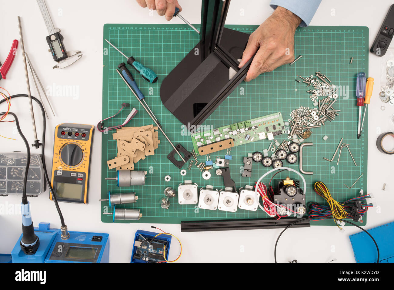 manual assembly of electronic mechanical device from a set of spare ...