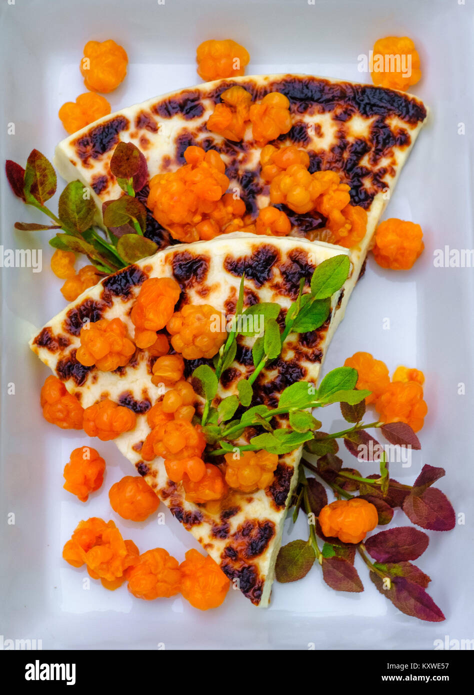 The original Lapland dessert squeaky cheese and fresh cloudberry  from Finland Stock Photo