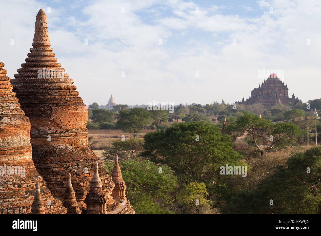 Two old and damaged brick stupas and Sulamani Temple at the Bagan Plain in Myanmar (Burma) on a sunny day, viewed from the Bulethi (Buledi) Temple. Stock Photo