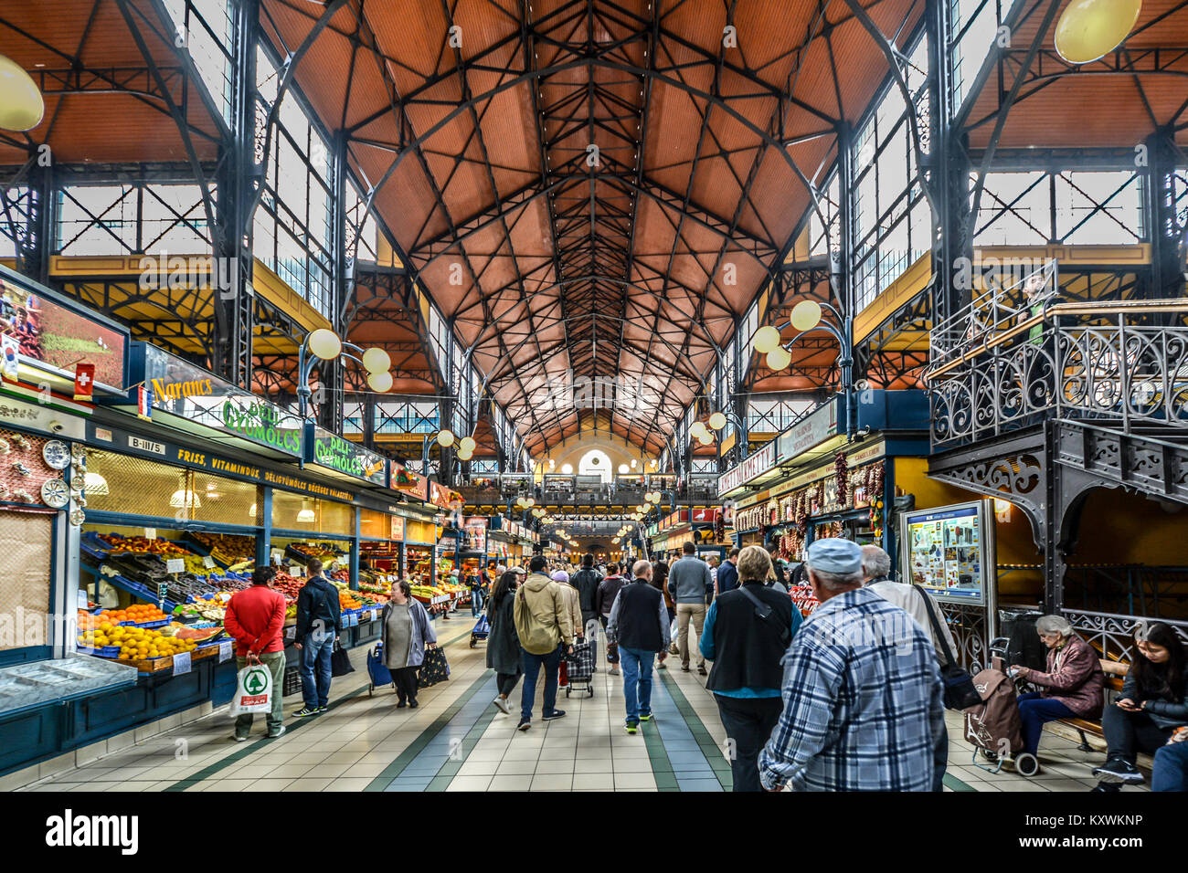 The Central Great Market Hall in Budapest Hungary selling groceries, produce and souvenirs with locals and tourists walking on the lower level Stock Photo