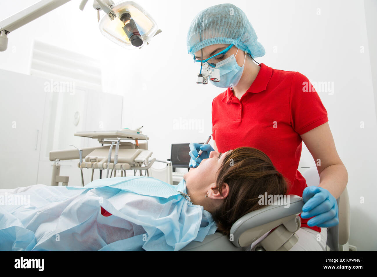 Doctor dentist treats teeth of a female patient. The woman on reception at the dentist. Doctor