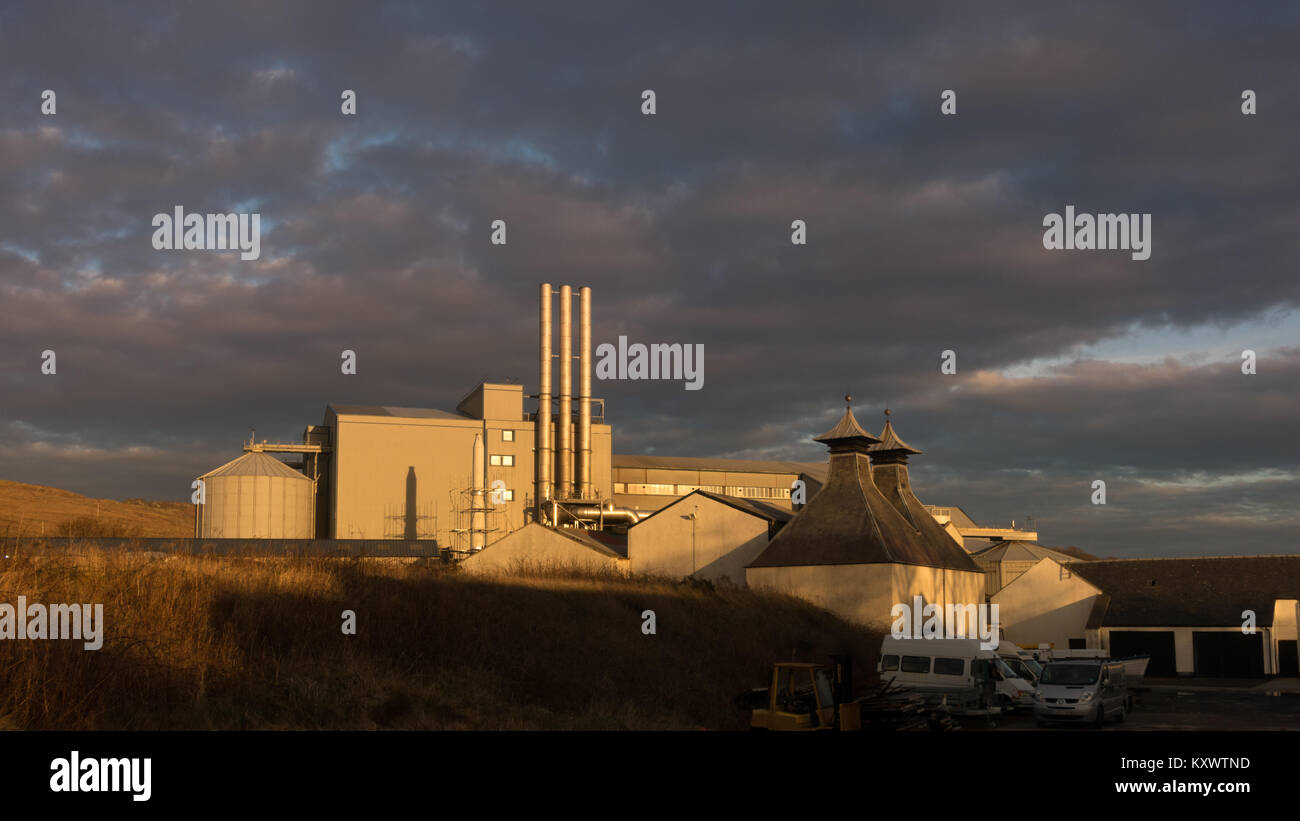 View of the outside of Port Ellen Maltings, Whisky Distillery in beautiful evening sunshine, Isle of Islay, Scotland Stock Photo
